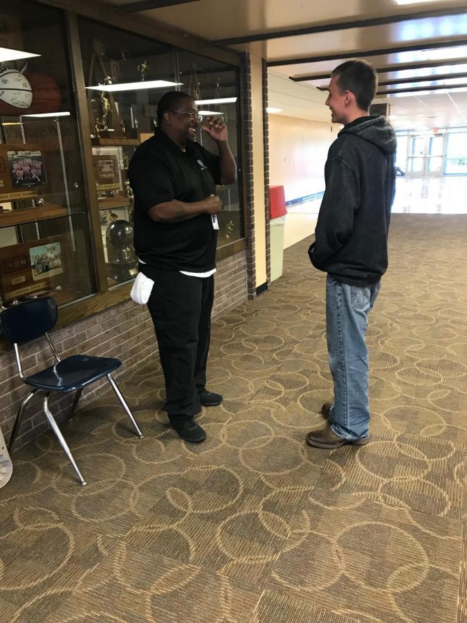 Marshal Potts (12) talks to security guard Nick Harris during lunch in the upper commons.  Harris sees part of his job as not only keeping the students safe but also supporting them. 