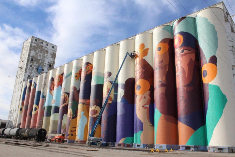 The mural stands on the east side of the elevator in Wichita. The use of the obsolete grain elevator shows how useless, dilapidated buildings can be turned into beautiful works of art.
