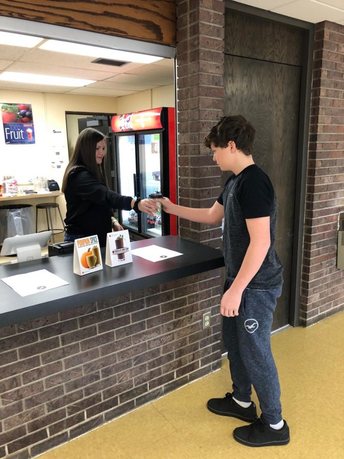 Cheyenne Pohlman (11) hands Everett Latimer (10) his beverage from the coffee shop. The Early Bird Cafe had a wide selection of blenders, smoothies and frappe. 