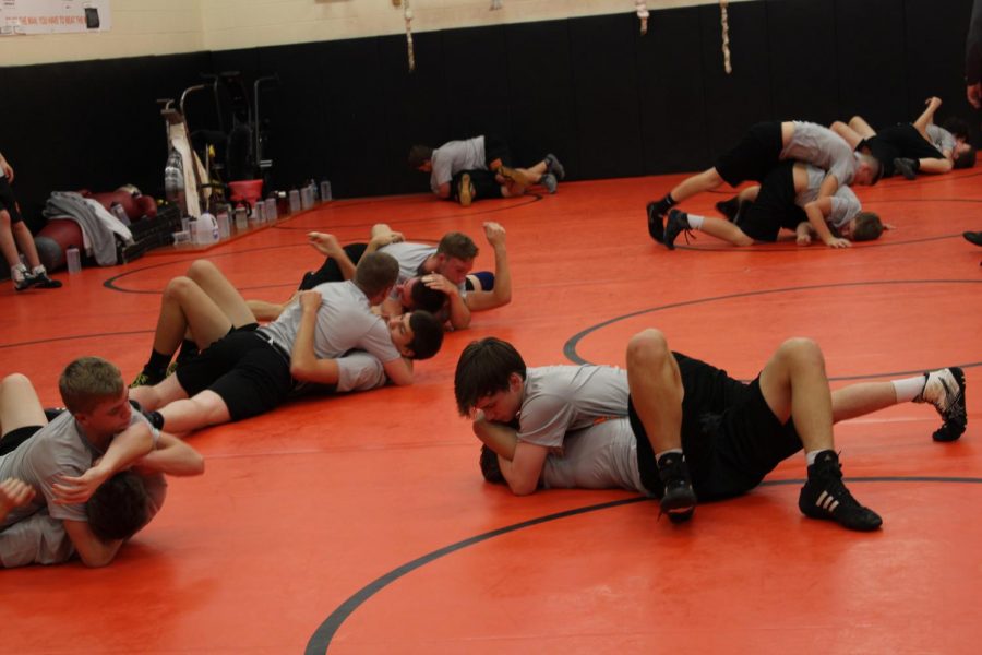 Members of the wrestling team practice in the wrestling room after school. They worked on a  move called the reverse half.