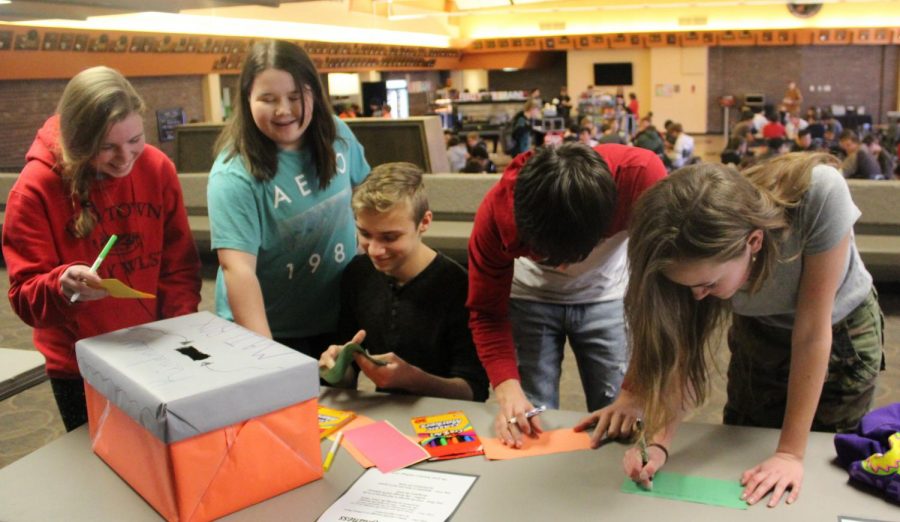 Sophomore Grace Stueven, senior Lilly White, sophomore Brendon Wedel, and sophomore Ellie Craft write kind anonymous letters to students during 2019’s Kindness Week. Counselors this year decided not to do The Great Kindness Challenge because of scheduling. 