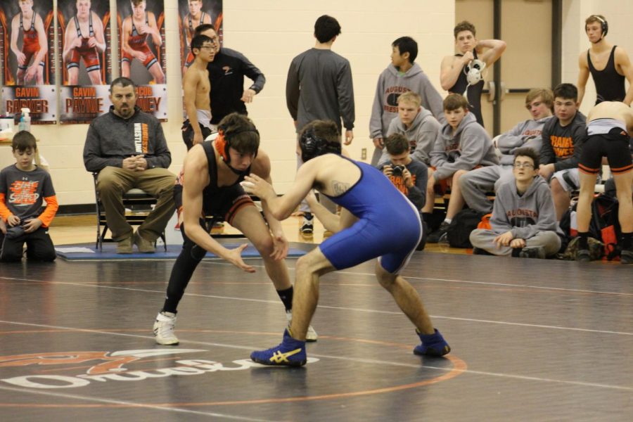 Gabe Fox (12) gets in his ready stance to face his opponent during the senior night wrestling dual. Because icy weather caused school to cancel, the varsity wrestling meet was moved from Thursday, Feb. 7 to Friday, Feb. 8 at 2 p.m., where the team won the dual against Circle.
