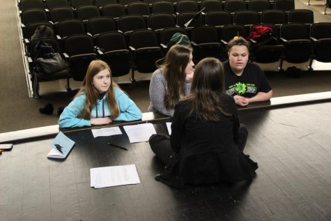 Carly Condella (11) practices lines with Amber Braddy (12), Ariana Ramseyer (9) and Katelyn Moore (12) during auditions for the play in the auditorium. Auditions were held Jan. 31 after school. 