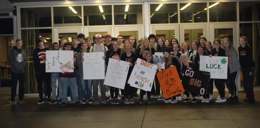 After riding in two separate spirit buses, members of the Os Zone hold up their handmade posters. After winning against Chapman, they returned to Tonys Pizza Event Center the following Saturday to face Kansas City Piper.
