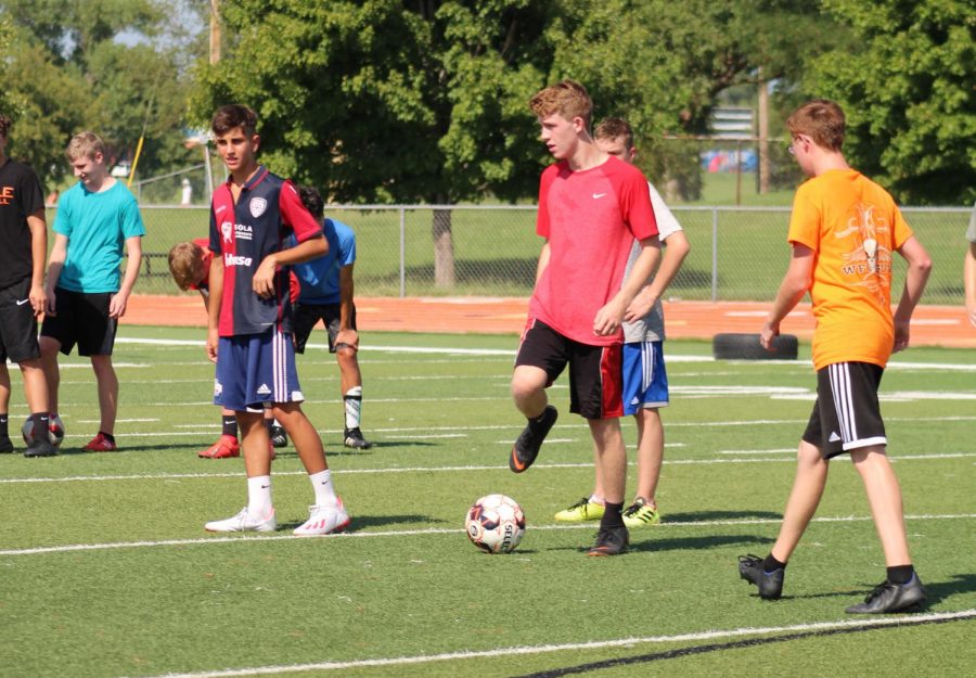 Athletes trying out for the soccer team prepare to run drills at the first practice.  The Orioles won their first game against El Dorado.
