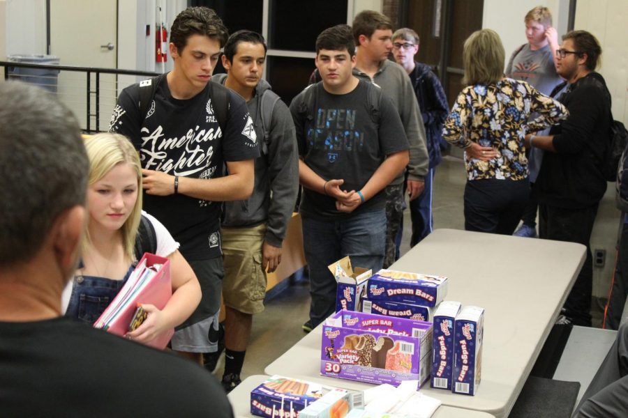 Sophomore Mercedes Bentley is walking through the line to pick out her ice cream followed by senior Austin Merz, senior Trenton Arredondo, and senior Raul Leedy at the No Tardy Party October 9th.