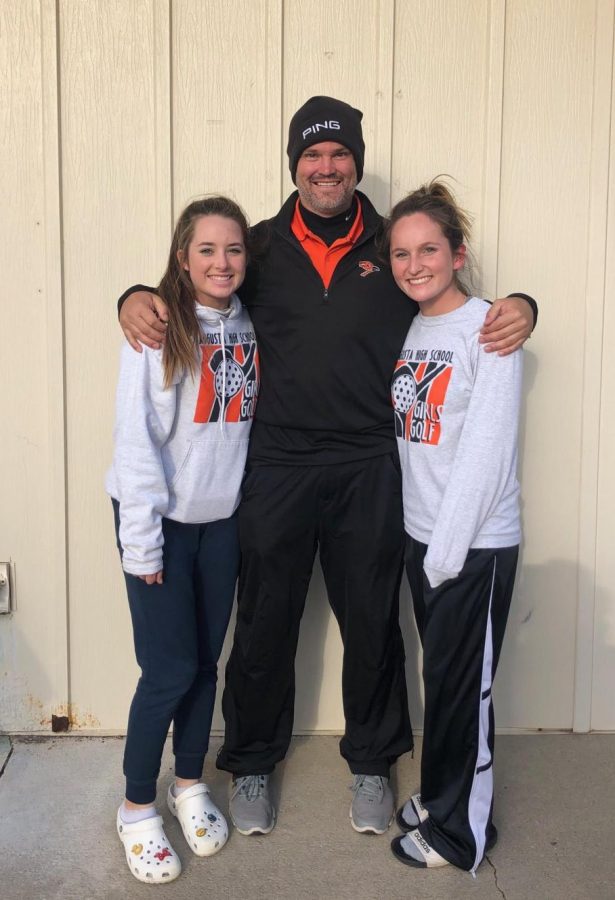 Freshman Alexa Zweifel, girls golf coach Danny Lundberg and senior Sarah Price posing in front of a building at the 4A State Golf Tournament.