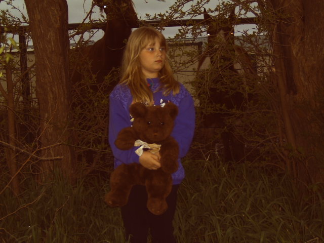 Raven Holland, around age six, holds a stuffed bear. Holland spent eight years in the foster care system before being adopted by her great aunt.