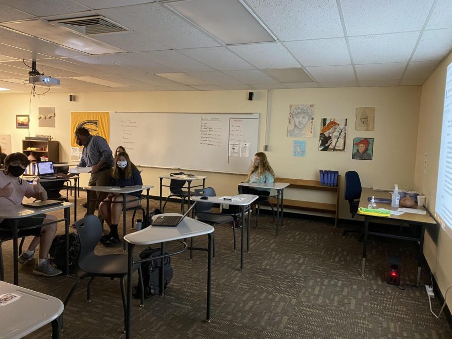 Sophomores+Tanner+Parscal%2C+Alicia+Matney+and+Elisa+Stubby+sit+in+Bradley+Raines+2A+World+History+class+during+a+projected+Zoom+call.+Students+last+names+L-Z+attended+in-person+Tuesday+and+Friday+while+A-K+attended+Monday+and+Thursday.%0A%0A