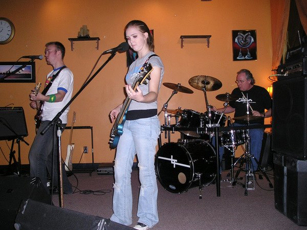 Science teacher Joe Connor plays drums with his Leave Thursday bandmates Dave Kerwood and his sister Bre Kerwood. They played multiple Christian rock songs for the group in front of them.
