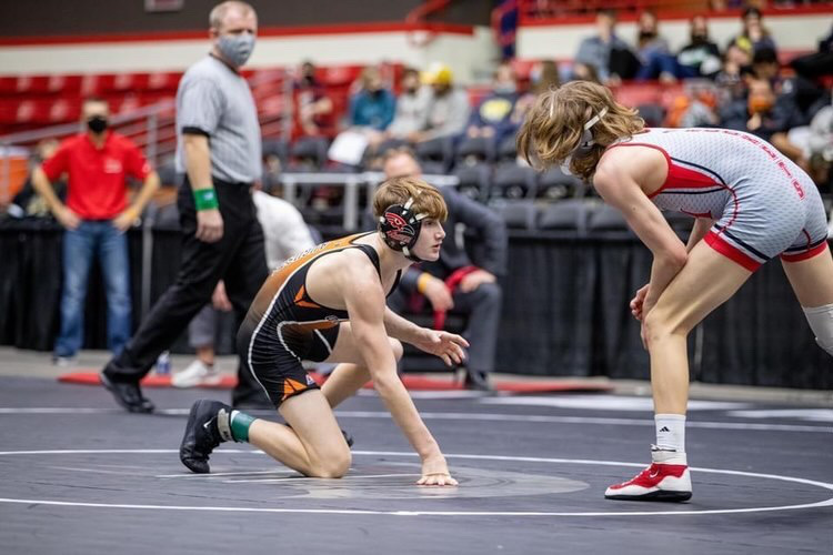 Preparing to hand fight with his opponent, sophomore Marcus Terry wrestles in his last match of the weekend. The match would decide if he would place first or second in the 106 weight class. Going into the day, Terry was at the top of his bracket.