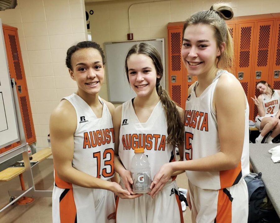 Senior Maycee Anderson, sophomore Aspen Peterson and junior Allie Timberlake pose with a Gatorade after being hype-teammates after winning a game. All of the girls were chosen to be recognized as the hype-teammate.