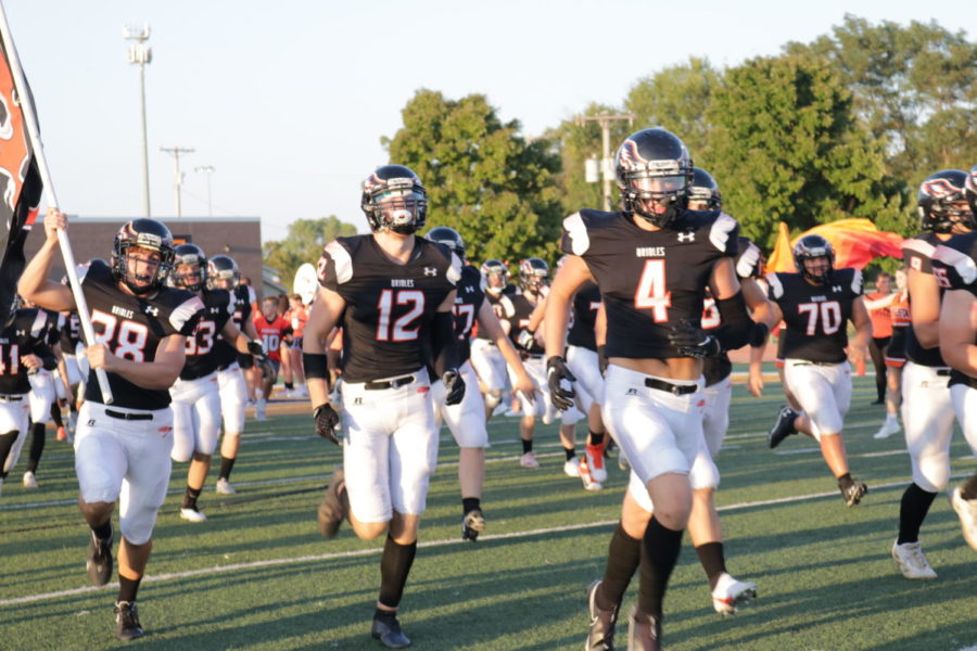 The football team runs onto the field in their new jerseys. The team was surprised with these black jerseys a couple of hours before kick-off, adding onto the orange and white jerseys they got earlier in the season.
