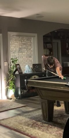 Junior Ignacio Compte Duch plays pool in his living room. In his free time in America, he likes to play pool. “I havent been here a lot but when I have free time I like to play pool,” Compte Duch said.