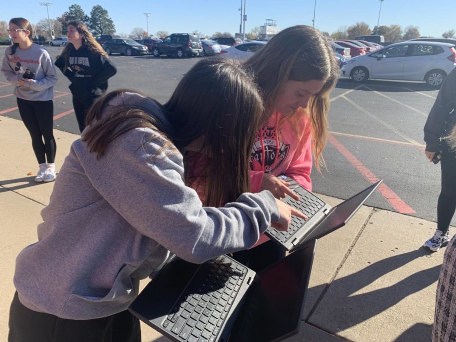 Seniors Kallie Smith and Charlize Lichlyter work together on their speech project during a fire drill. Even with a fire drill you cant stop us from working on this project, Smith said. 