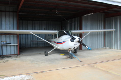 This plane is an example of high wing aircraft, which is shown by the location of the wings on the plane. This plane is placed in a hanger located at the airport, and private planes can also be stored at these hangers.
