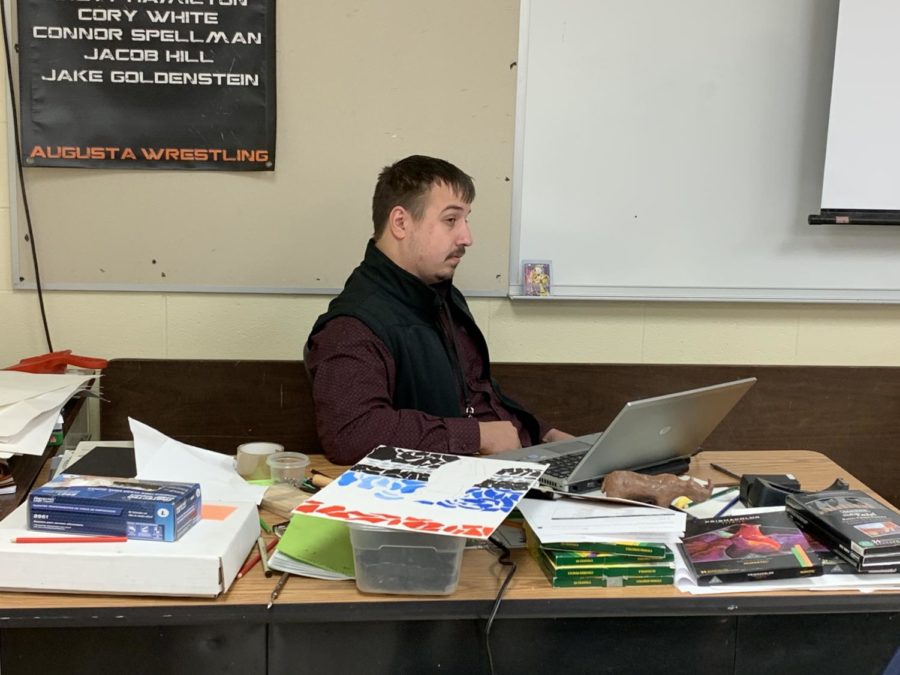Long-term substitute teacher Connor Spellman observes his 3A Intro-to-art class. The class was working on a paper collage animal as their final for the semester.