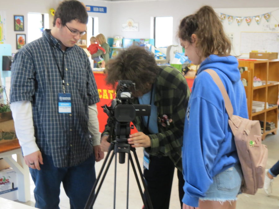 Junior Lucien Newcombe and seniors Cody Wilson and Alex Quezada set up the camera they call Boss for their story about Kansass Largest Classroom. The teams original drawn topic was about sheep, but the sheep judging was over so they were given this topic as a replacement.