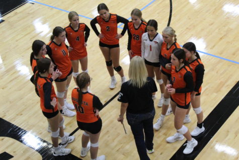 The freshmen volleyball team huddles up at the tournament in Andover Central. It took place on August 27, 2022.
