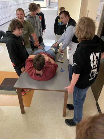 Social studies teacher Conner Spellman demonstrates how war medics would have operated on wounded soldiers. This demonstration was part of Spellman’s unit on the Civil War.
