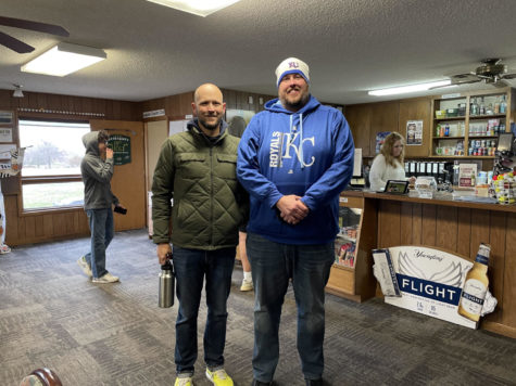 Coach Holtzinger and Assistant coach Hull in the club house. they are both dressed warm because of the cold temperatures.