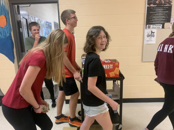 Sophomores Tyler Henman, Dalton Cox-Peek, Reagan Stillwell, Danika Jackson and Alicen Hues walk through the science hallway selling snacks to students during ACE. They are doing so to raise money to buy snacks for the freshman and juniors for Test Fest. 
