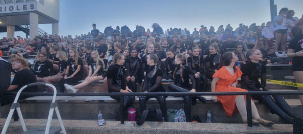 Marching band members wait for a timeout to play their songs at the Friday football game. The band, along with cheerleaders and dancers perform at every home football game.