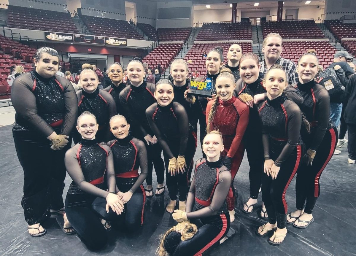 Winterguard+members+gather+for+a+photo+after+placing+second+at+Kansas+City+color+guard+regionals.+The+team+will+travel+to+Dayton%2C+Ohio+April+9-14+to+perform+in+WGI+World+Championships.