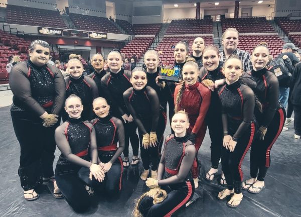 Winterguard members gather for a photo after placing second at Kansas City color guard regionals. The team will travel to Dayton, Ohio April 9-14 to perform in WGI World Championships.