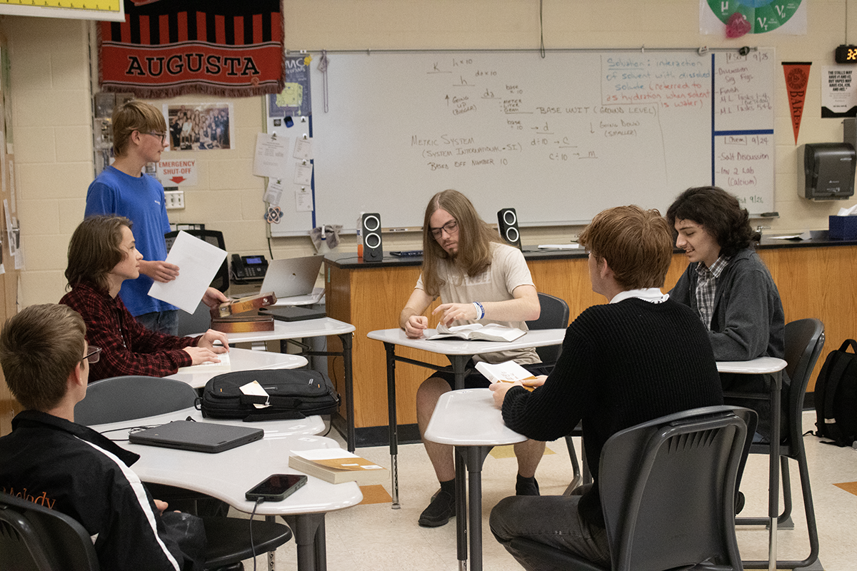 After their daily prayer, freshman Caleb Christensen starts a discussion about Bible verses. This new Bible study meets every Tuesday at 3:15 p.m.
