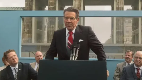 President Ronald Reagan (actor Dennis Quaid) gives his famous speech at the Berlin Wall. At this point in history, Reagan told the Soviet president, “Mr. Gorbachev, tear down this wall.”
