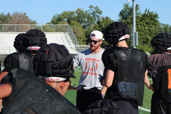 Head football coach Dawson Elliott explains a play to the offense during after-school practice in Hillier Stadium. The Orioles take the field against Abilene Friday, Oct. 11.