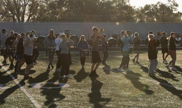 Members of the marching band practice steps for “The Heist” show during early morning practice in Hilliar Stadium. The Marching Orioles placed 2nd in the ESU Marching Festival, Oct. 9. They competed against 5A and 6A schools.

