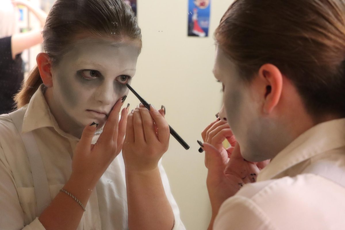 Alex Mobley prepares her stage makeup for her role as an ancestor