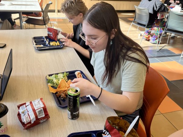 Junior Adelie McQueen drinks a Monster Energy during lunch. McQueen often shares energy drinks with her friends in ACE.
