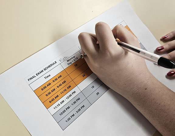 A printed finals schedule shows the times students take their last tests for the semester and the required study sessions. Administration implemented a detention policy first semester for students who did not attend the afternoon study sessions. 