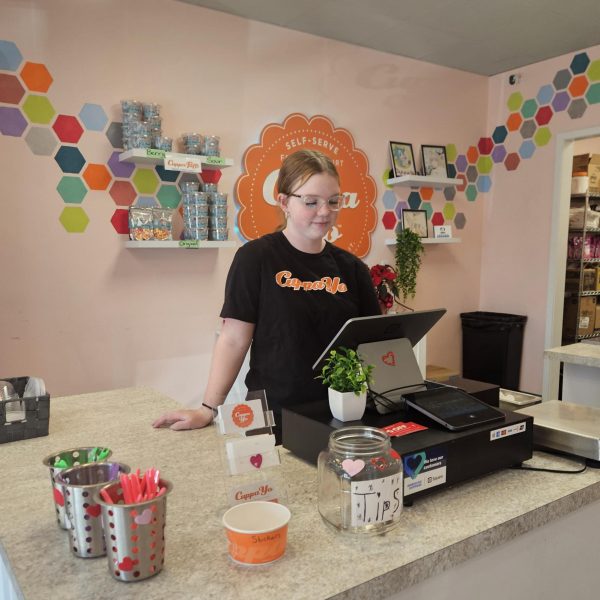 Freshman Evee Hoard clocks in at her job at Cuppa Yo’. Hoard started her job through her grandma’s business. 
