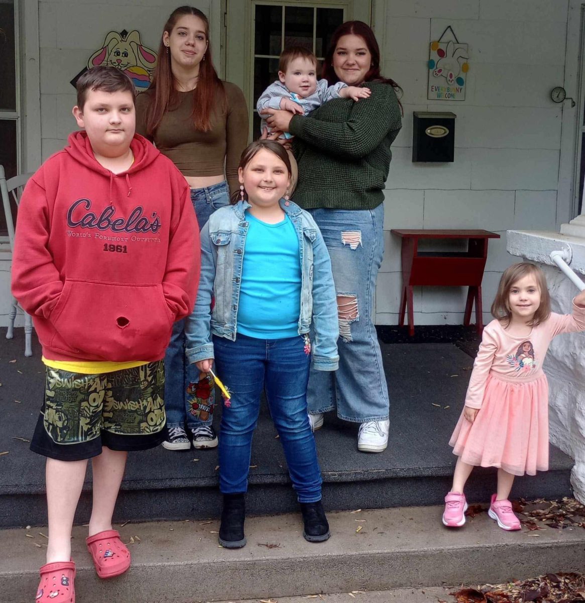 Abigail Brinkley and Emily Brinkley take pictures at their grandmas house with their four younger cousins. Emily and Abby like to spend time with their younger cousins.
