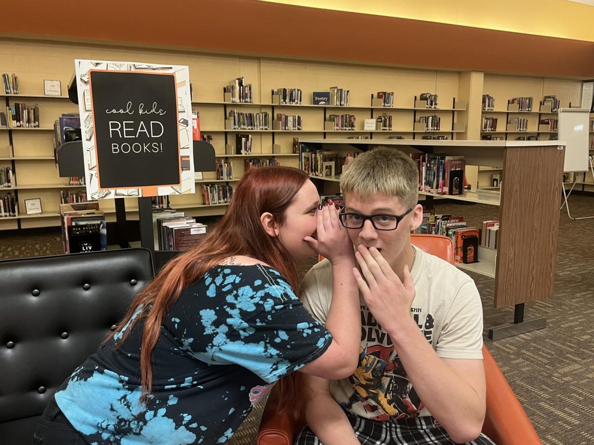 Reporters Harley Williams and Mason Pringle pose for a photo in the library. The library is open during lunch for students to sit and talk.