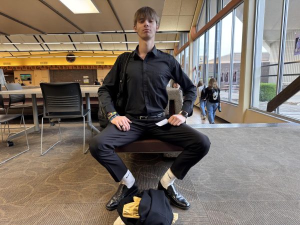 In the commons, Junior Kayden Neild poses in his jazz-band attire. He just finished with a jazz premormance at Lincoln Elementary School.