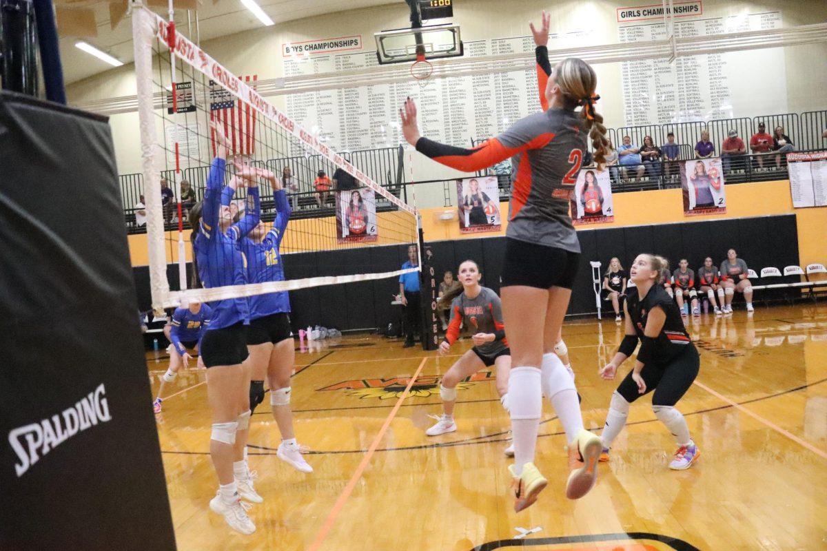 Varsity team seniors Adelaide Fleming and Molly Marteney watch the ball as senior Delaney Ratcliff prepares for a spike over the net. The next JV and varsity home games will take place Oct. 14 against Mulvane and Circle at 5 p.m.