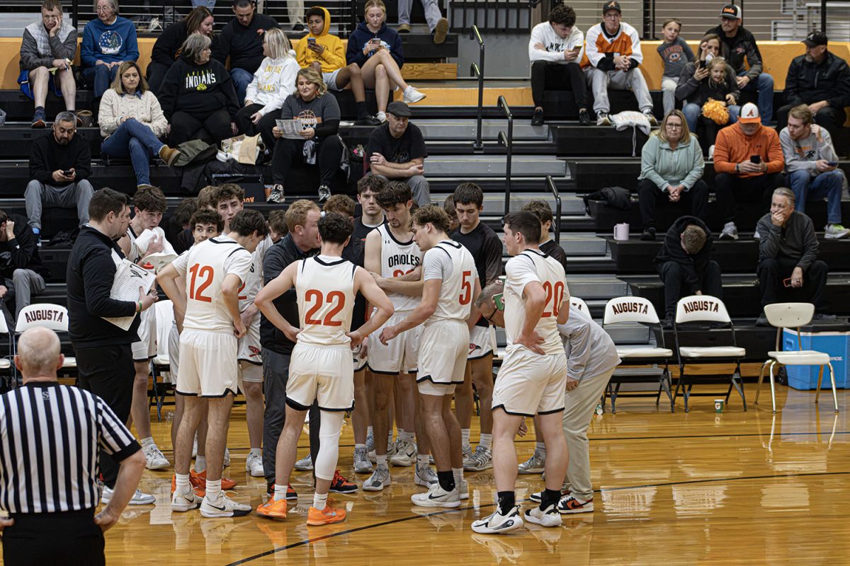 Varsity coach Ryan Petty encourages his team to hustle and do their best during the game Jan. 27 at Augusta High School. He shouted instructions from the sideline and motivated the players to keep their energy up. Petty pushed his team to work hard so they could come out with a win. They ended up losing to Andale 35-56.

