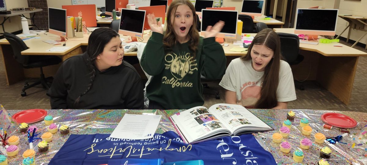 Returning staff members, senior Adrien Green and juniors Haley Browning and Charleigh Shaver react after seeing last year’s yearbook in Walsworth’s “Possibilities”. Every other year, Walsworth reviews thousands of yearbooks, but only selects 10 percent for the nationally recognized book. 