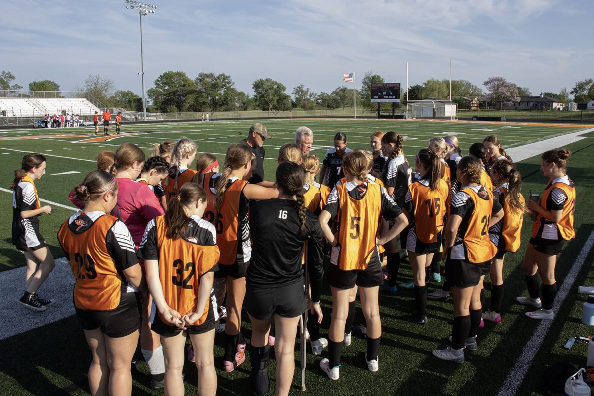 Coach Childers pumps up the girls soccer team before playing an intense match against winfield at Hillier stadium April 13. The girls go on to beat Winfield 8-0.
